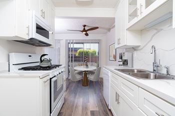 Modern kitchen with gas stove and built- in microwave